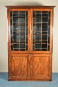 A GEORGE IV MAHOGANY ASTRAGAL GLAZED TWO DOOR BOOKCASE, the square panelled glazing enclosing two