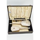 A CASED SILVER VANITY SET, black case which opens to reveal a hair brush, mirror and a comb, each