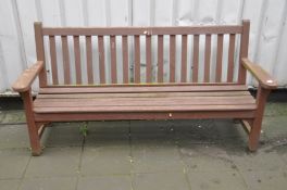 A HARDWOOD GARDEN BENCH with slatted seat and back, width 193cm