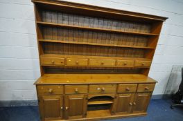 A LARGE PINE FARMHOUSE DRESSER, the top with five drawers, over a base with five drawers above