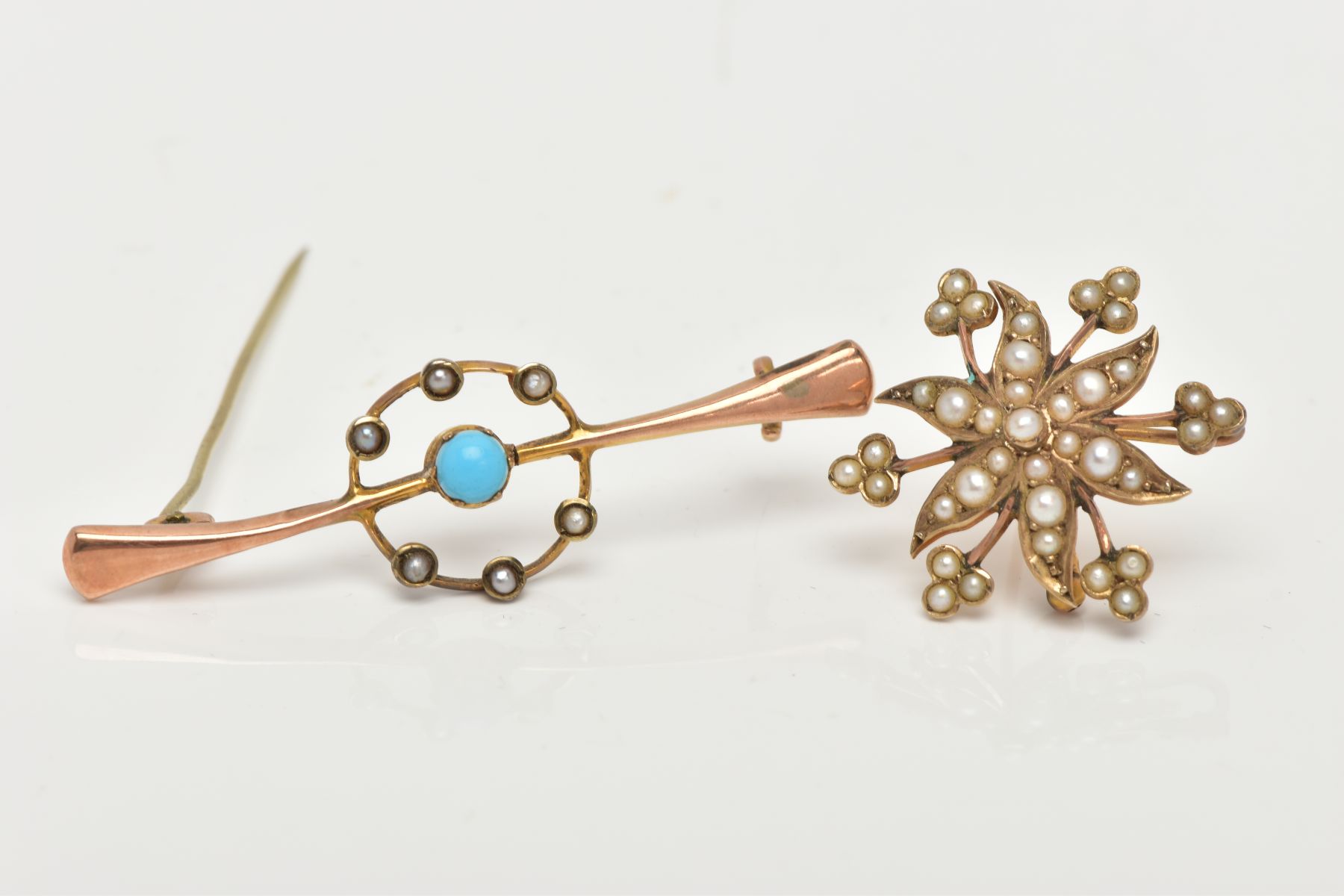 TWO EARLY 20TH CENTRURY GOLD BROOCHES, the first brooch of a yellow gold floral design, set with