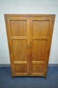 HEAL & SON LTD OF LONDON, AN ARTS AND CRAFTS LIMED OAK PANELLED TWO DOOR WARDROBE, enclosing a