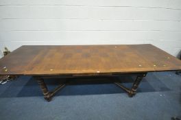 A FRENCH OAK PARQUETRY EXTENDING DINING TABLE, on turned legs, united by a shaped stretcher, open
