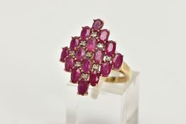 A 9CT GOLD RUBY AND DIAMOND CLUSTER RING, of a lozenge shape, set with a cluster of oval cut