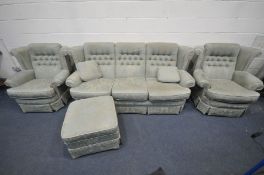 A FLORAL GREEN UPHOLSTERED LOUNGE SUITE, comprising a three seater sofa, pair of armchairs and a