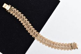 A YELLOW METAL BRACELET, a textured link open work bracelet, fitted with an integrated push pin