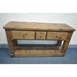 A PINE RUSTIC SIDE TABLE, with two long drawers flanking a single slim drawer, on block legs, united