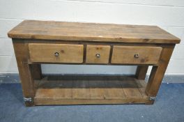 A PINE RUSTIC SIDE TABLE, with two long drawers flanking a single slim drawer, on block legs, united