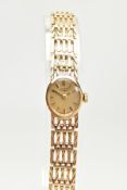 A 9CT GOLD LADIES WRISTWATCH, a hand wound movement, oval gold tone face, signed 'Rotary' batton