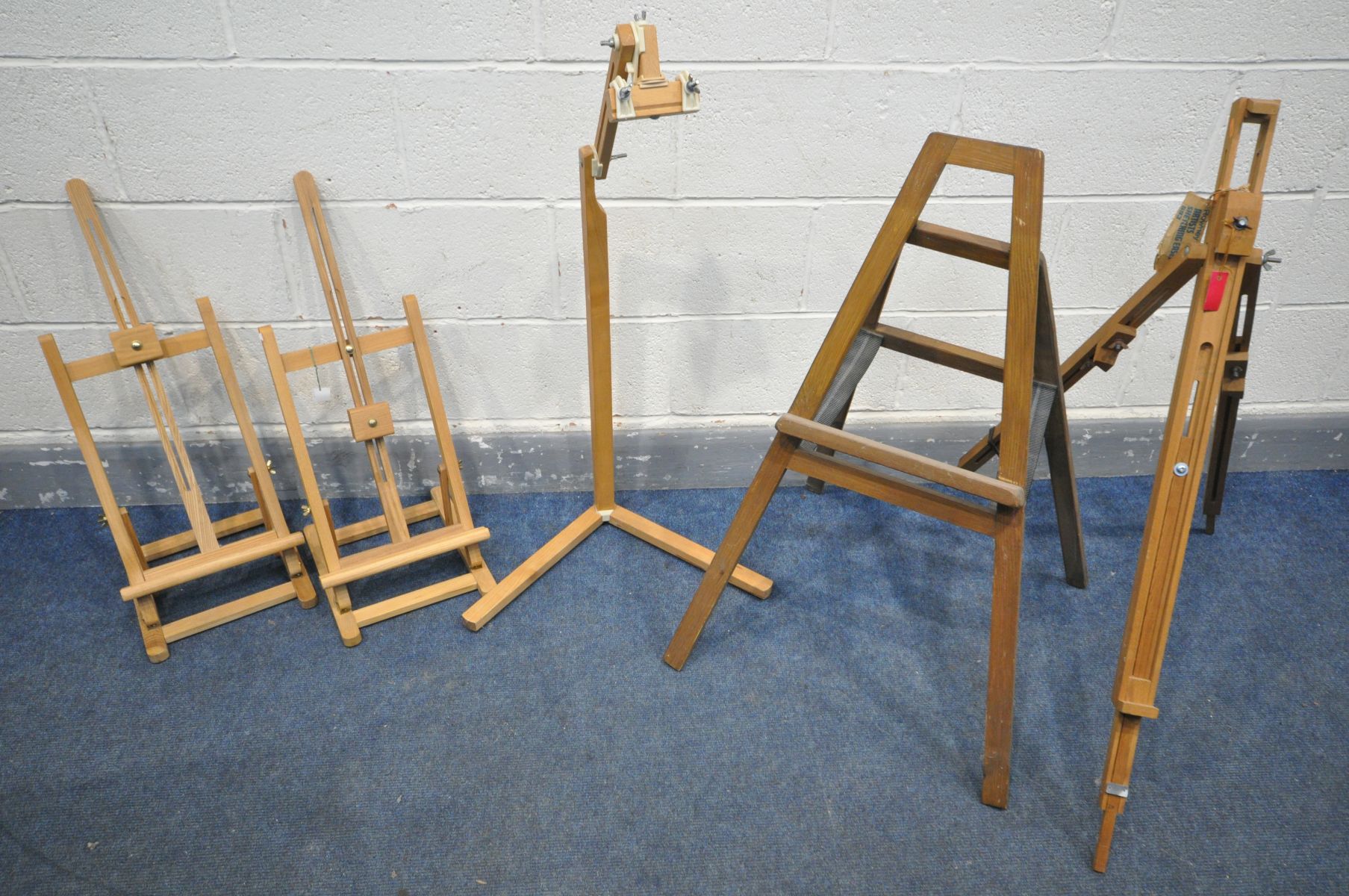 A VARIETY OF ARTIST EASELS, to include a pair of surface top easels, a Posi lock stand (losses) a