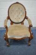 A VICTORIAN WALNUT BUTTONED SPOONBACK ARMCHAIR, with foliate carved cresting, open armrests,