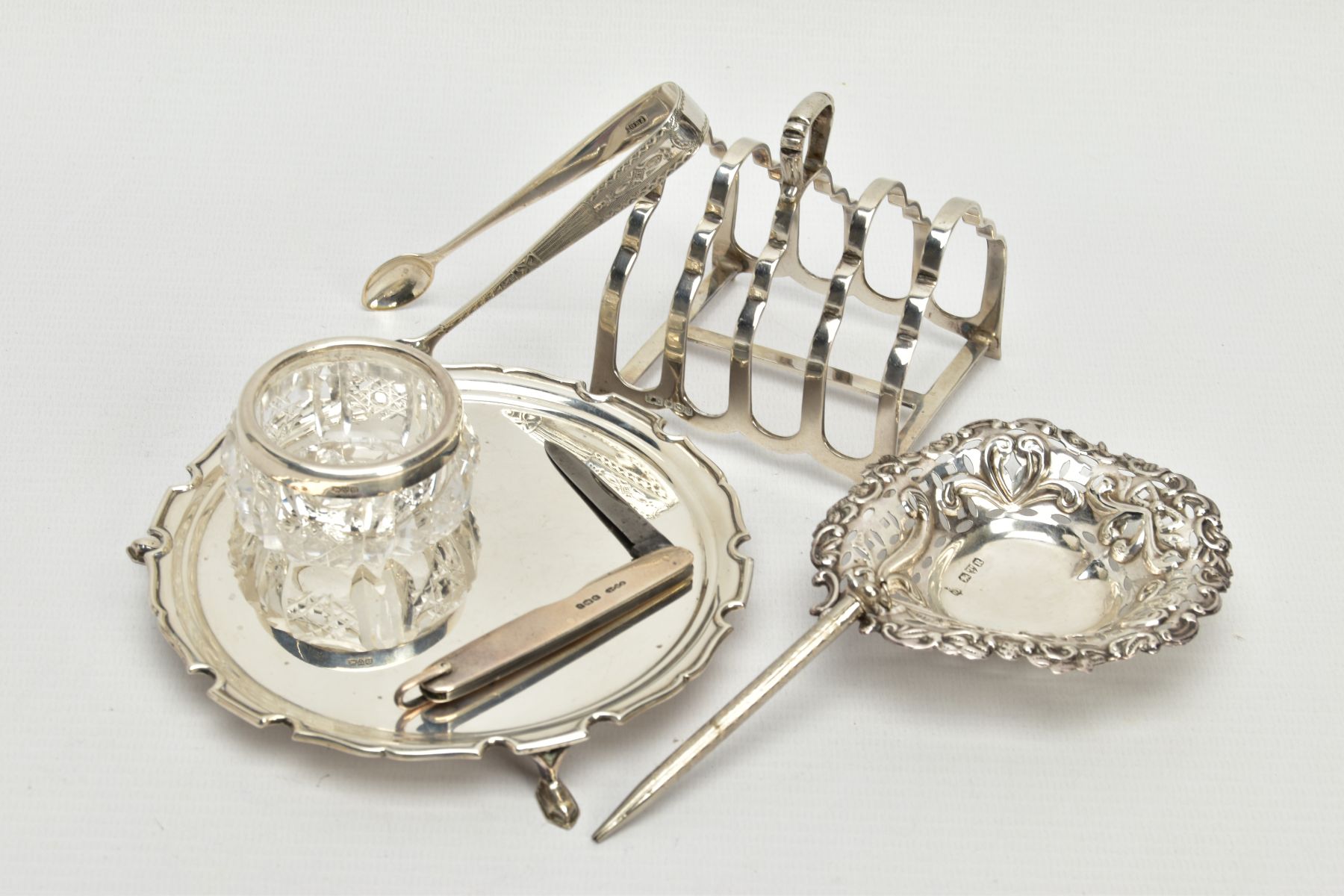 A SELECTION OF SILVER ITEMS, to include a small toast rack hallmarked 'Frank Cobb & Co Ltd'