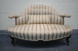 A LATE VICTORIAN CANAPE SOFA, with a shaped back and open arm rests, on scrolled front legs, a