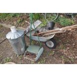 A GALVANISED FIRE TUB together with a metal wheel barrow, push along scarifier, wooden step