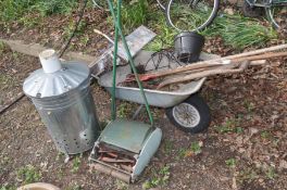 A GALVANISED FIRE TUB together with a metal wheel barrow, push along scarifier, wooden step