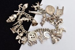 A WHITE METAL CHARM BRACELET, curb link bracelet fitted with twenty-four charms in forms such as a