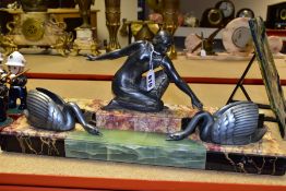 AN ART DECO SPELTER AND MARBLE FIGURE GROUP OF A LADY WITH TWO SWANS, she is kneeling on a three