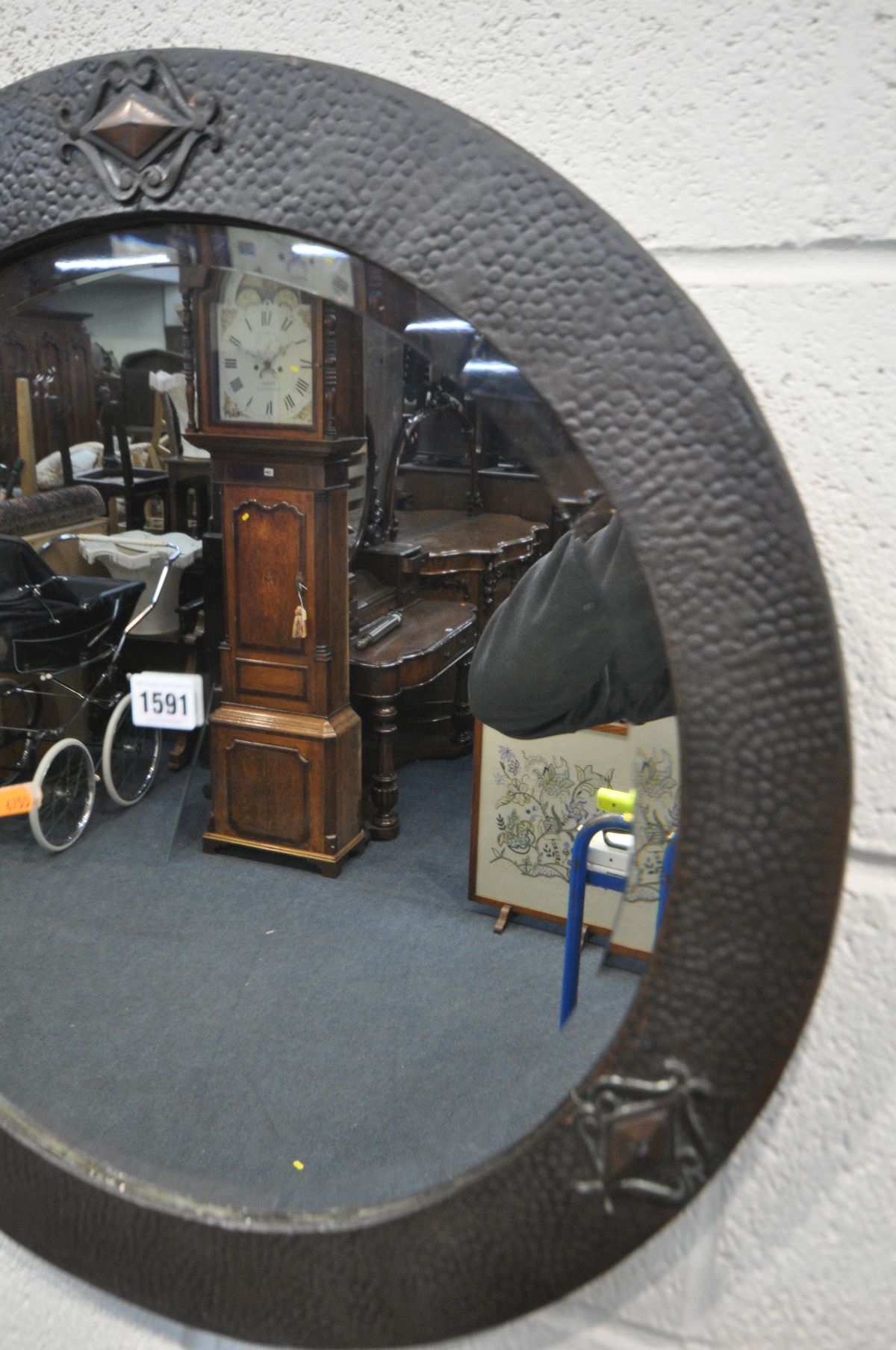 AN ARTS AND CRAFTS BEATEN COPPER CIRCULAR WALL MIRROR, with a bevelled edge plate, 56cm diameter ( - Image 2 of 2