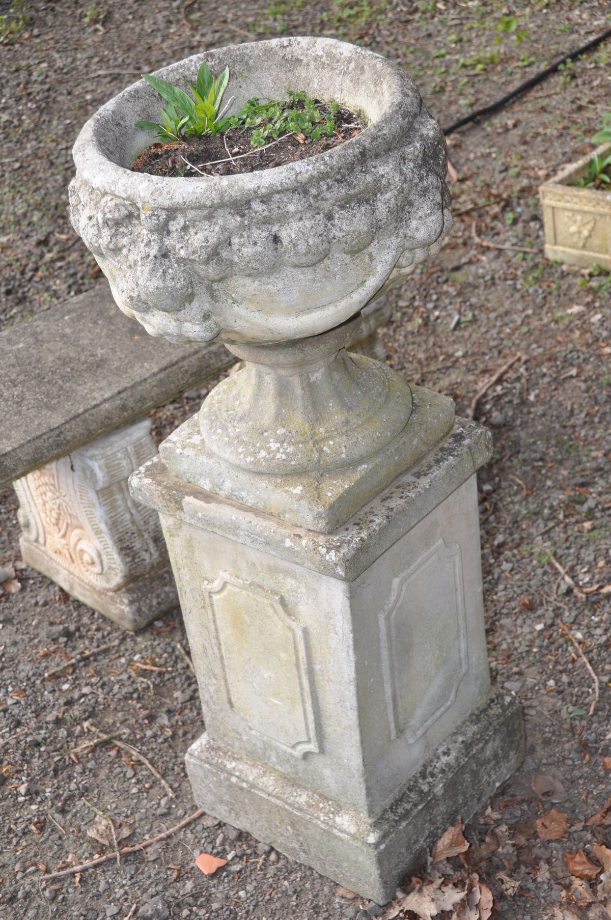 A COMPOSITE CIRCULAR URN, with decorated sides, on a separate square plinth, height to plinth - Image 2 of 3