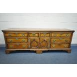 A GEORGE III OAK AND WALNUT CROSSBANDED DRESSER BASE, moulded top edge, quarter columns to front