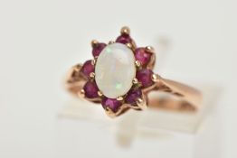 A 9CT GOLD OPAL AND GARNET CLUSTER RING, oval opal cabochon with circular shape garnet surround,