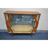 A MID CENTURY TEAK CHINA CABINET, with two decorated sliding doors, enclosing two glass shelves,