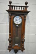 A LATE 19TH CENTURY WALNUT VIENNA WALL CLOCK, with a pair of fluted finials, eight day movement,