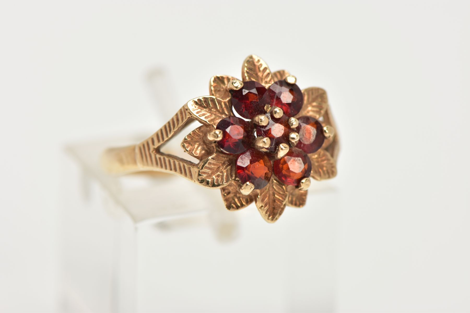 A 9CT GOLD GARNET FLORAL CLUSTER RING, designed as a circular shape stepped garnet cluster, with - Image 4 of 4