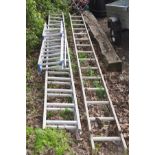 A SET OF ALUMINIUM 4M DOUBLE EXTENSION LADDERS together with a single 4M set of ladders and three