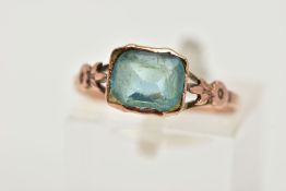 A YELLOW METAL BLUISH GREEN PASTE SINGLE STONE RING, an oval shape bluish green paste in a collet