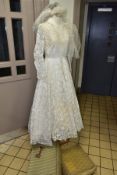 A VINTAGE WEDDING DRESS AND VEIL, in ivory with ivory and gold lace, full length, long lace