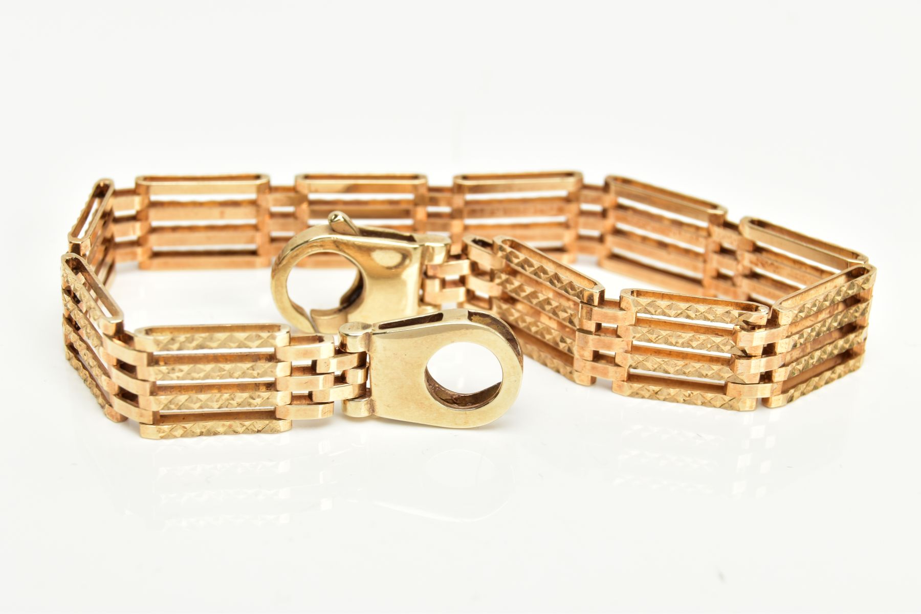 A 9CT GOLD GATE BRACELET, four bar gate bracelet diamond cut pattern to the one side the other a - Image 4 of 4