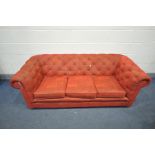 A RED UPHOLSTERED THREE SEATER BUTTON BACK SOFA, length 190cm (condition - general signs of usage)