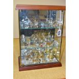 A GLASS DISPLAY CABINET CONTAINING CRYSTAL STYLE ORNAMENTS, to include animals, musical instruments,