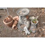 A COMPOSITE TWO TIER BIRD BATH surrounded by otters (cracks and loose parts lower bowl),