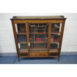 AN EDWARDIAN MAHOGANY DISPLAY CABINET, with a pierced lattice pattern gallery, single door,