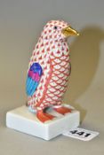 A HEREND RED FISHNET FIGURE OF A PENGUIN STANDING ON A SQUARE BASE, model no. 5176, gilt beak, multi