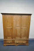 A PINE THREE DOOR WARDROBE, with two drawers, width 158cm x depth 57cm x height 191cm (condition:-