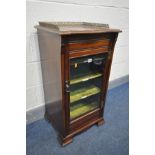 AN EDWARDIAN MAHOGANY MUSIC CABINET with a brass gallery, on casters, width 49cm x depth 43cm x