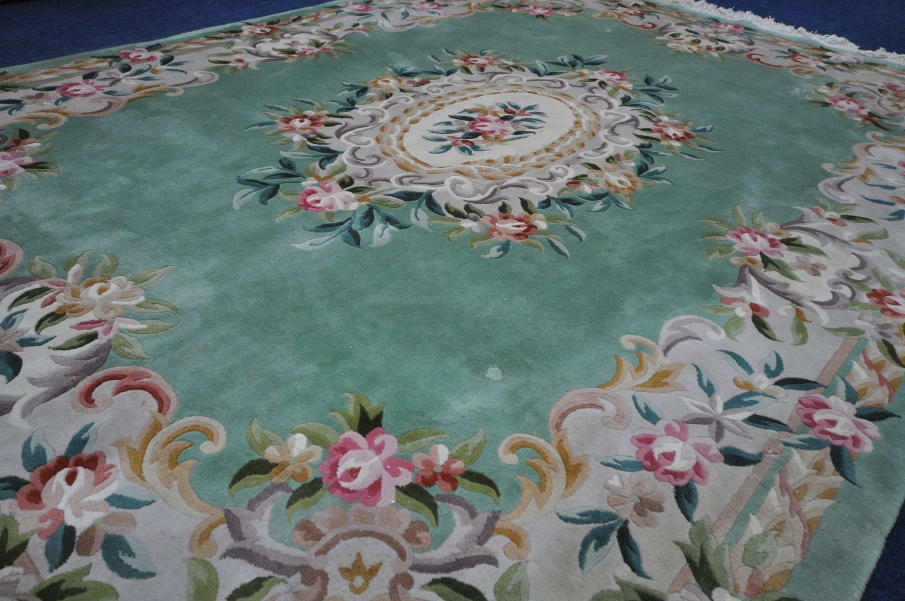 A LARGE CHINESE GREEN GROUND WOOLLEN RUG, with foliate design to centre and border, length 370cm x - Image 3 of 4
