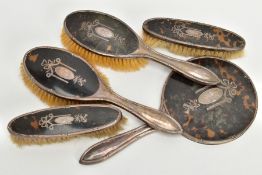 A FIVE PIECE EARLY 20TH CENTURY SILVER AND TORTOISE SHELL VANITY SET, comprising of a hand held