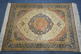 A 20TH CENTURY TABRIZ DEISGN SILK PILE RUG, the fields contrast with medallions and surrounds, the