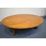 AN OAK DROP LEAF OVAL COFFEE TABLE, on turned legs and block feet, united by stretchers, length