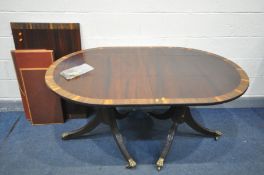 A REGENCY STYLE MAHOGANY AND CROSSBANDED TWIN PEDESTAL DINING TABLE, with a single additional