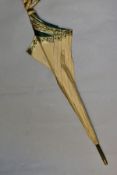 AN EDWARDIAN SILK PARASOL, cream silk canopy and green stained wooden shaft, approximate length