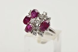 A WHITE METAL DIAMOND AND RUBY ABSTRACT DRESS RING, four oval cut rubies and nine round brilliant