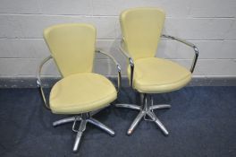 A PAIR OF VINTAGE BARBER CHAIRS, with cream leatherette upholstery and chrome arms, legs and foot