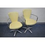 A PAIR OF VINTAGE BARBER CHAIRS, with cream leatherette upholstery and chrome arms, legs and foot