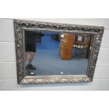 A LARGE RECTANGULAR SILVERED GILT WOOD BEVELLED EDGE WALL MIRROR, with carved foliate detail, length