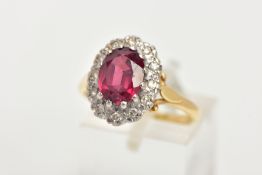 A YELLOW METAL GARNET AND DIAMOND CLUSTER RING, slightly raised cluster designed with a central claw